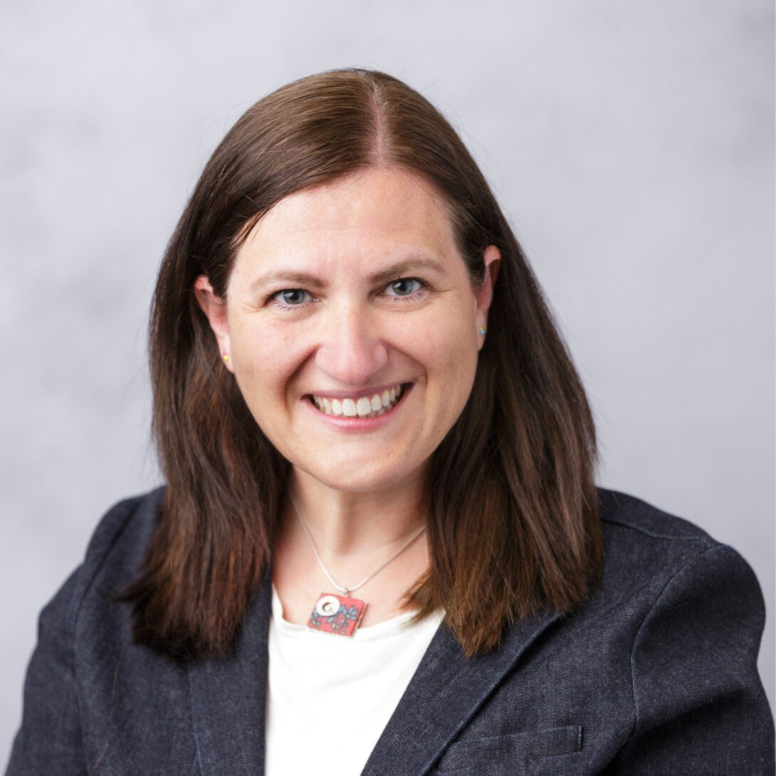 Dr. Elizabeth Papautsky smiles in dark blue blazer