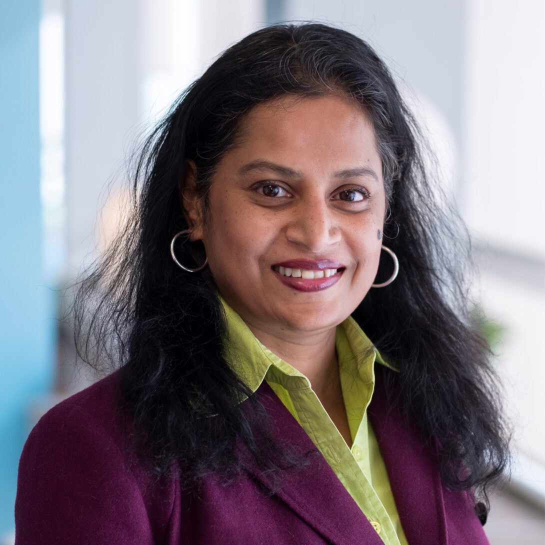 VP of Digital Innovation Development at OSF HealthCare, Roopa Foulger, smiles at camera in purple blazer