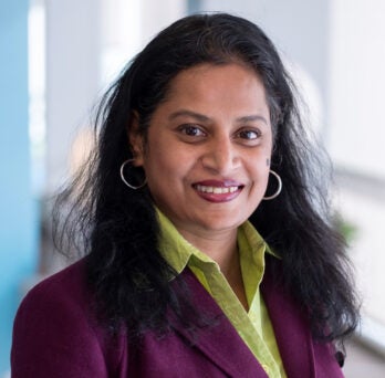 VP of Digital Innovation Development at OSF HealthCare, Roopa Foulger, smiles at camera in purple blazer 